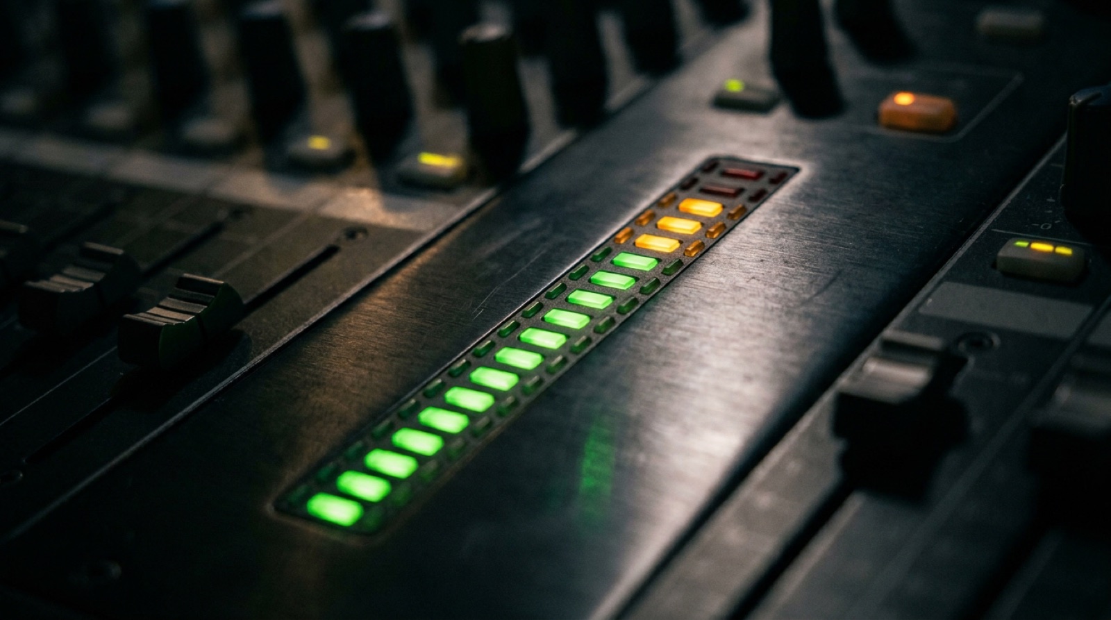 Level meters glowing on a mixer